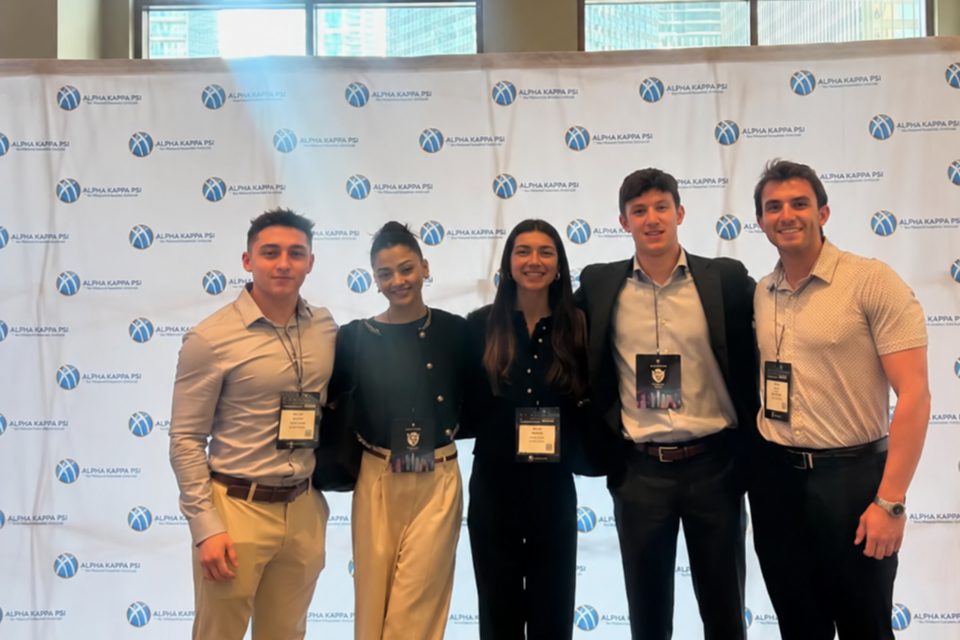 Beta Pi brothers in business attire at a Herbert Business School event