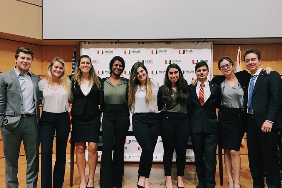 Beta Pi brothers in business attire at a Herbert Business School event