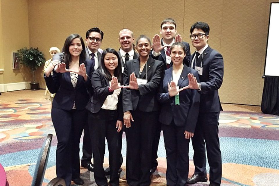 Beta Pi brothers in suits at a professional event