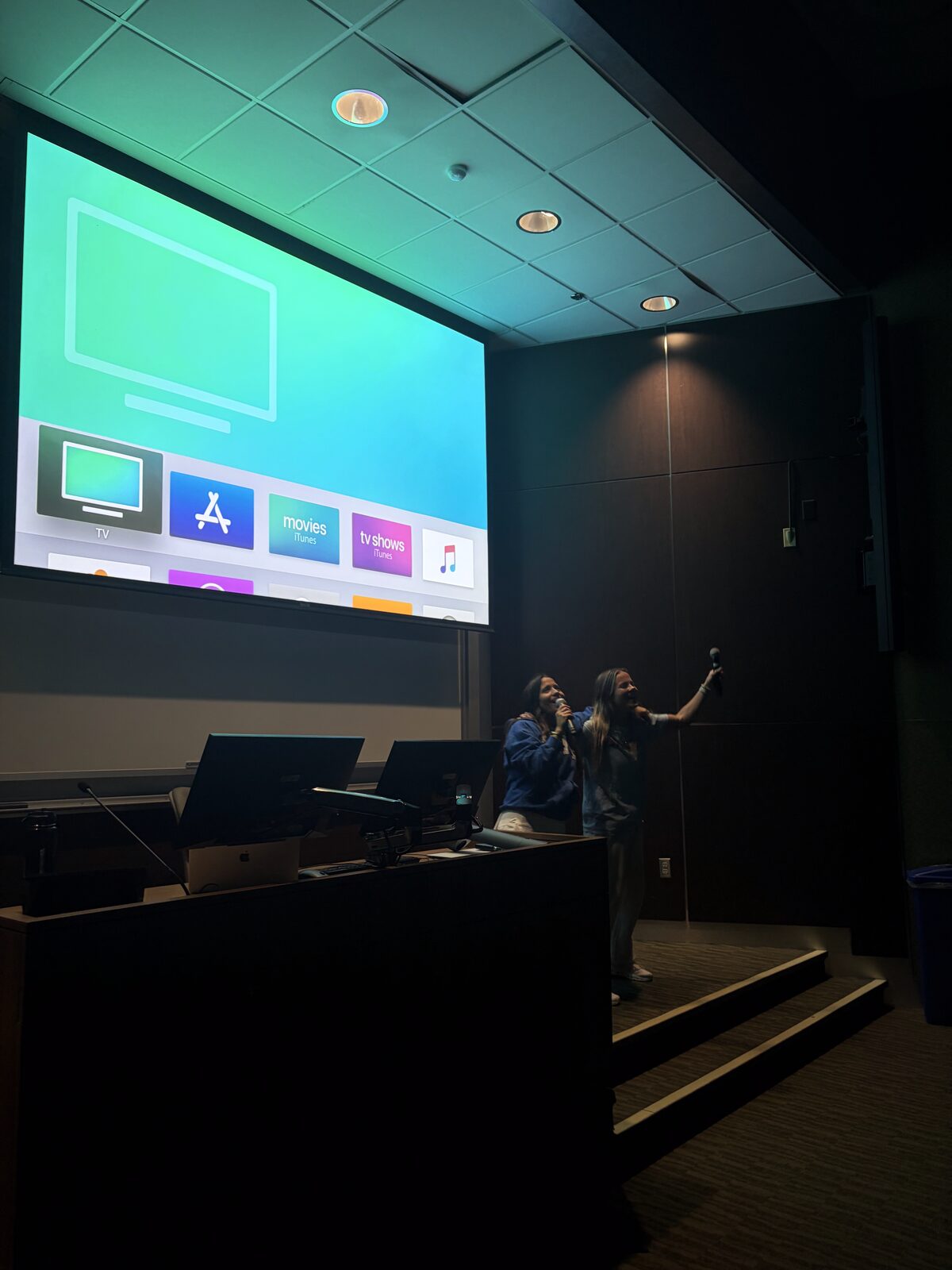 Brothers at the front of a lecture hall during an event