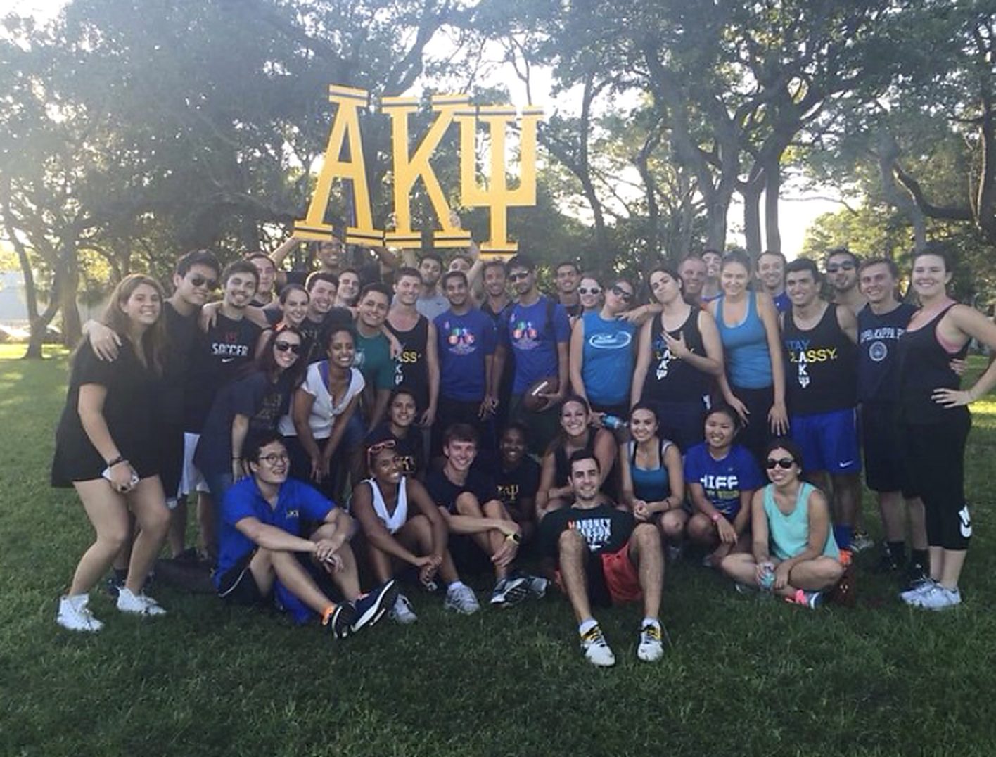 Beta Pi brothers with the AKPsi letters at a philanthropy event